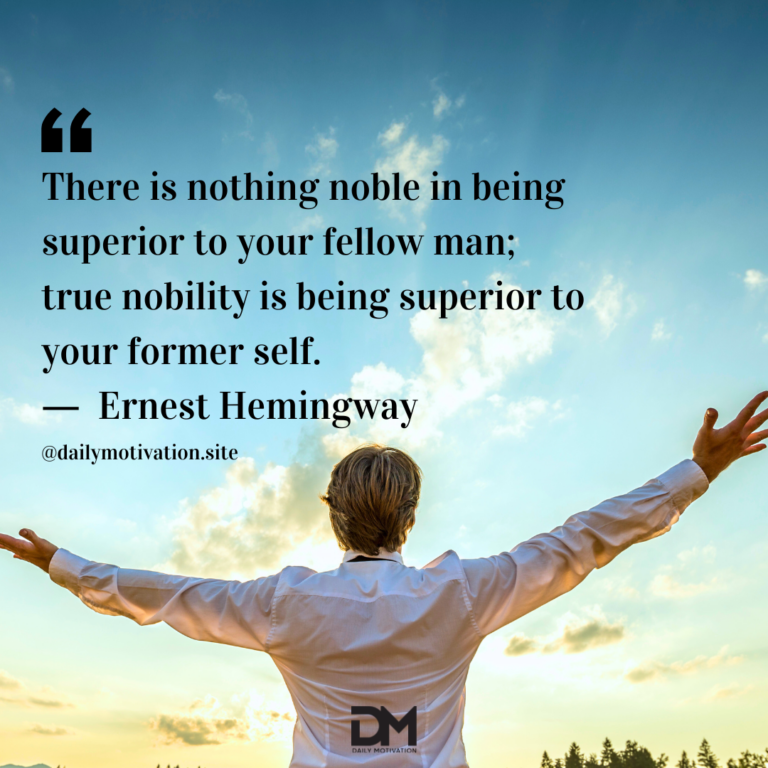 A man in a white shirt stands with his arms raised out to the blue and gold sky.