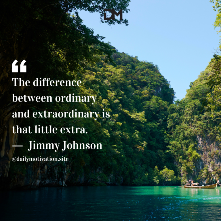 A still green-blue lake amidst towering trees.