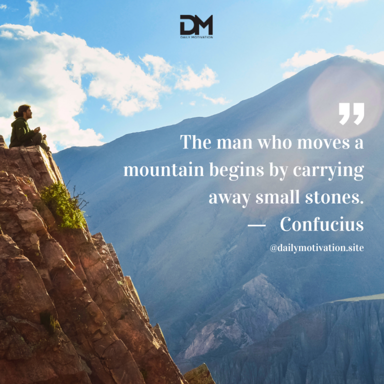 Someone sits atop a high cliff, looking at the blue mountains in the distance.
