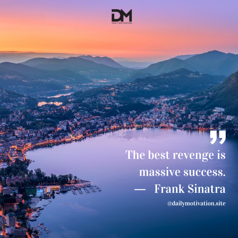 A birds eye view of a town lining a dark blue lake.