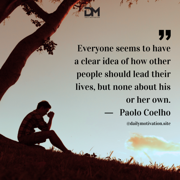 A silhouette of a person sitting on the ground in front of a tree at sunset.