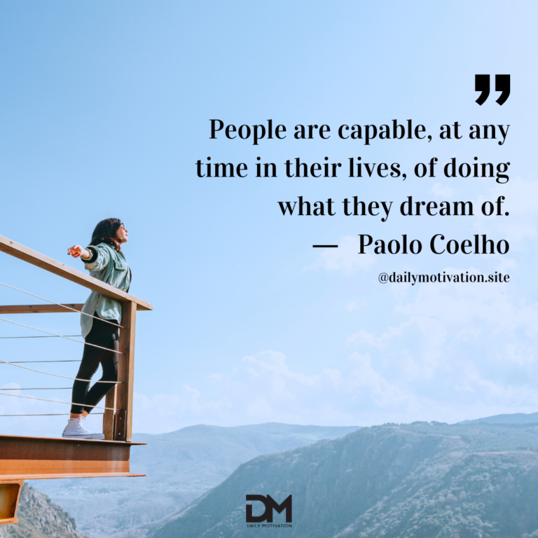 A woman stands on a balcony high in the sky with her arms out.