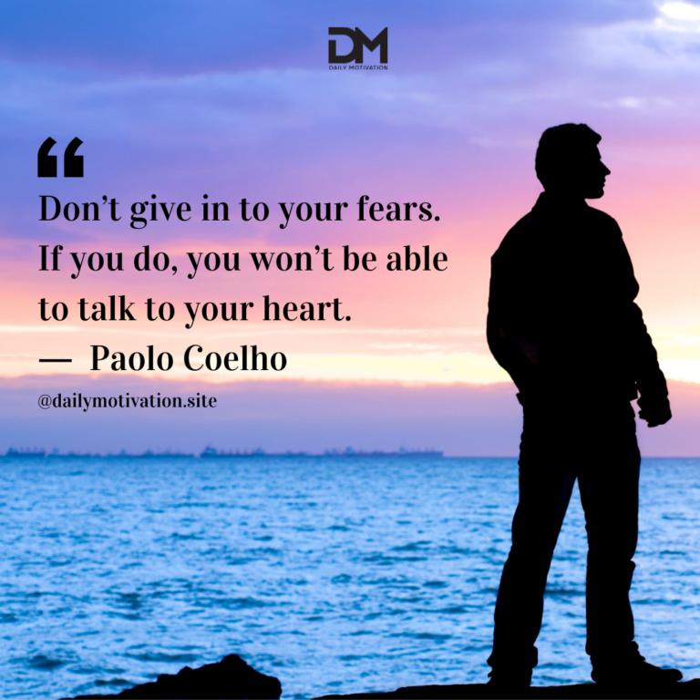 A man stands in silhouette against a darkening purple sunset over the water.