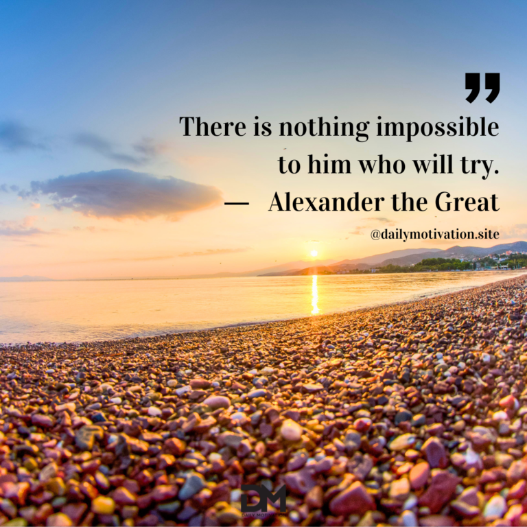A close up of tiny rocks on a beach with the sky and water in the distance.