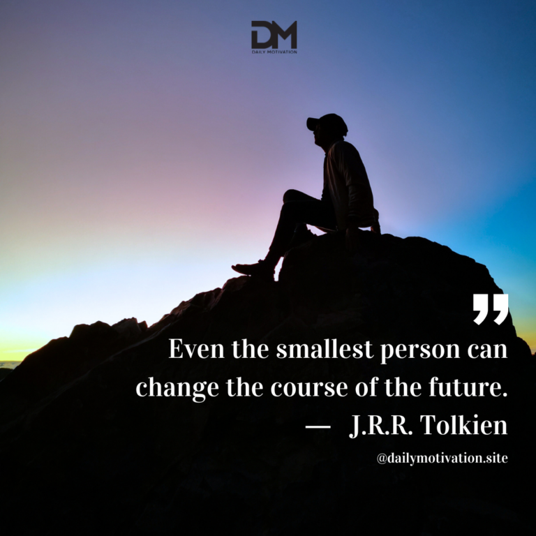 A person in silhouette sits on top of a rock looking up at the darkening sky.