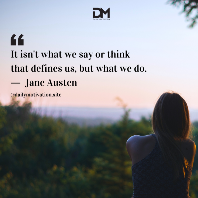 A person sits in silhouette in a field of grass looking out at the darkening sky.