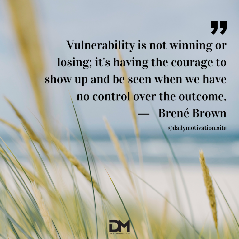 A close up of long yellow grass with a blurry beach and sea beyond.