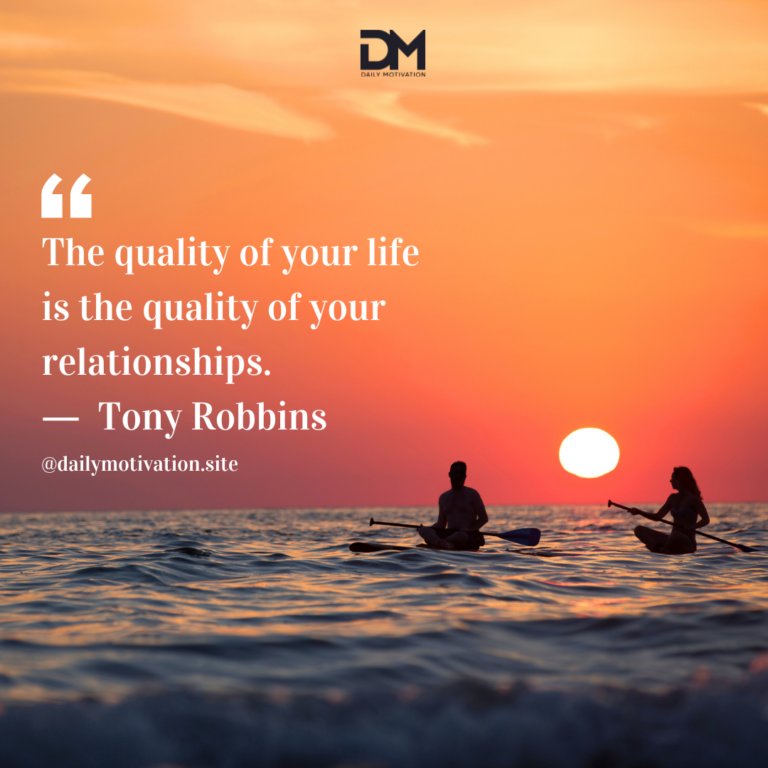 Two people sit in kayaks on the ocean with a setting sun in a bright orange sky.