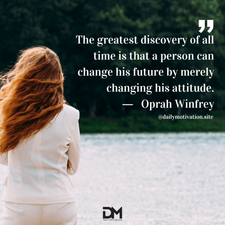 A woman with red hair and a white jacket stands facing a forest and river beyond.