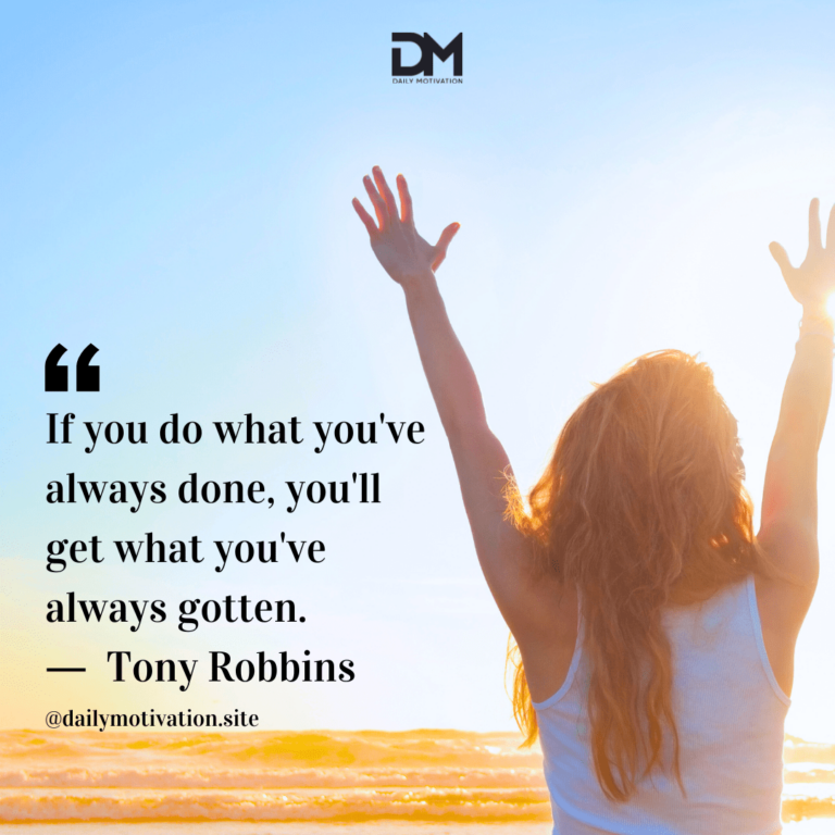 A woman in a white top raises her arms in the air in joy in front of a bright blue sky.