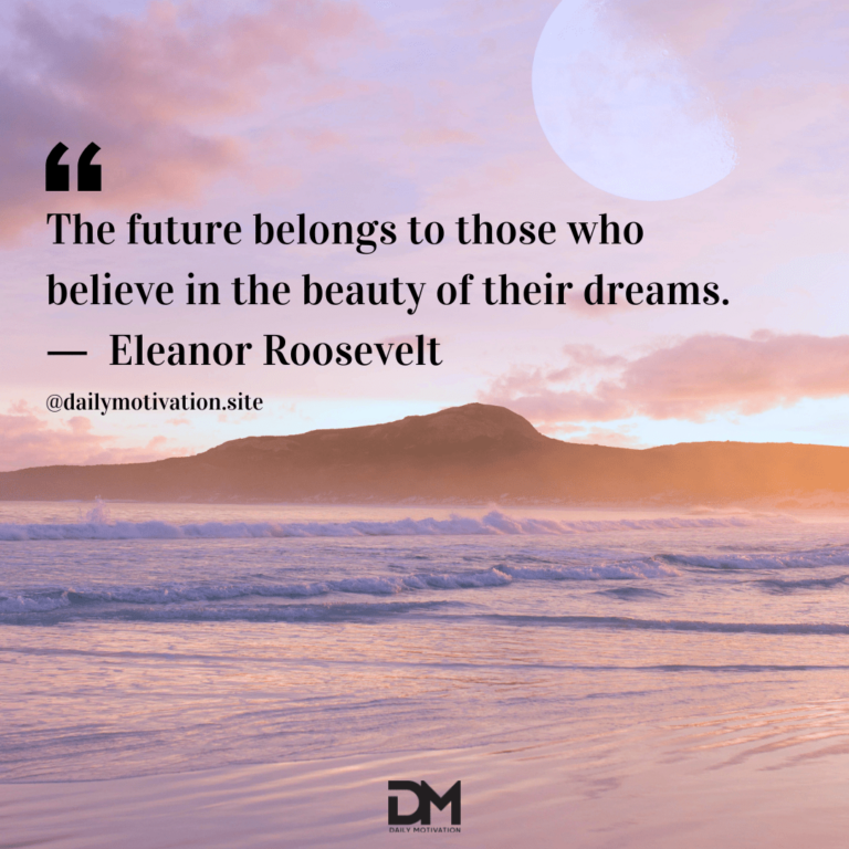 A soft pink sky at sunrise over lapping waves above the beach.