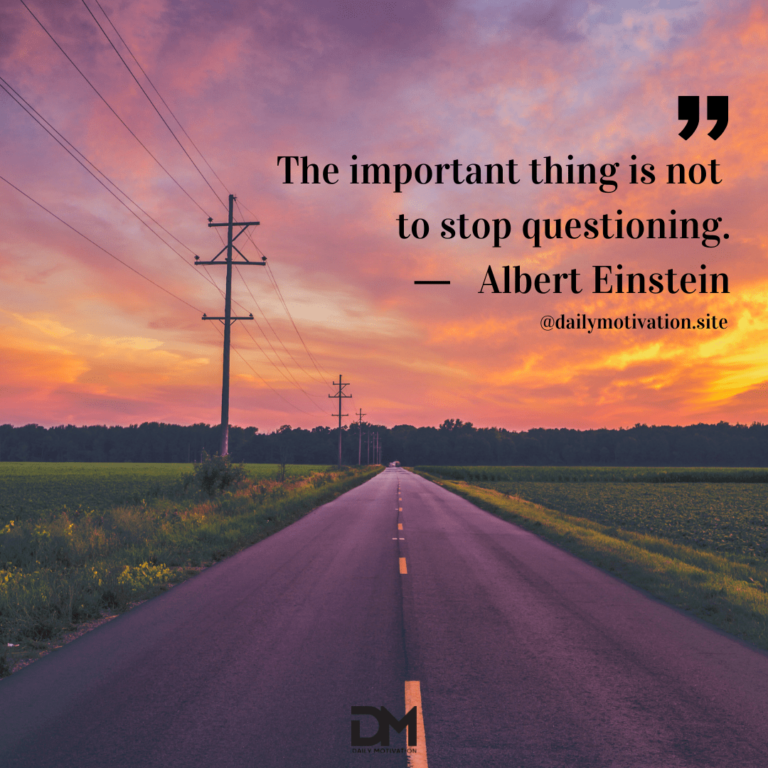 An empty highway in the middle of farm land with a pink sunrise beyond.