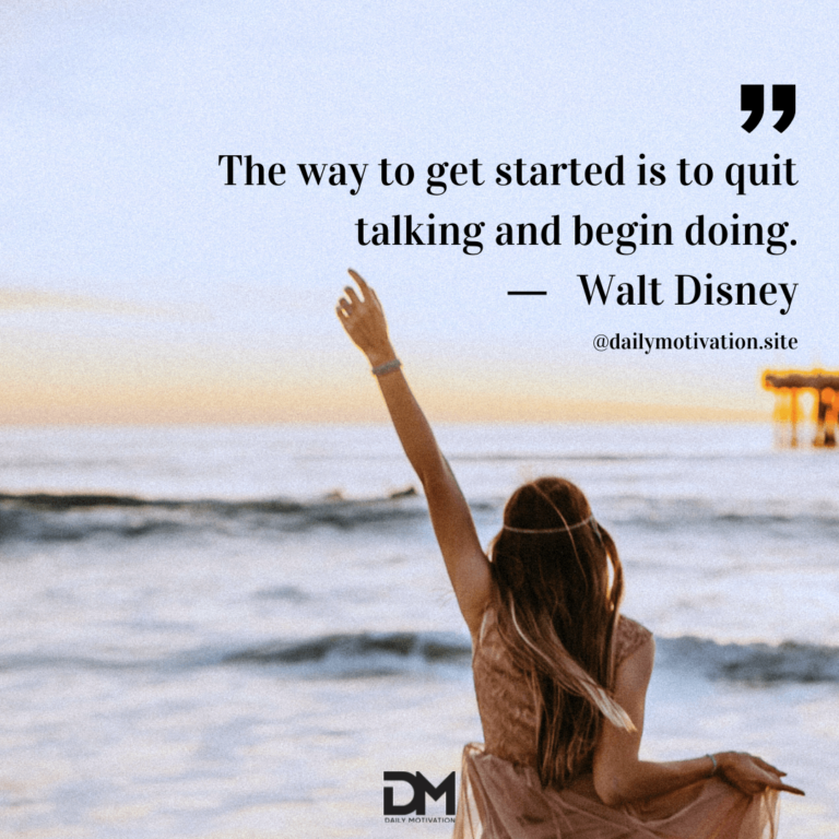 A woman sits on the beach with one hand raised in the air in triumph.