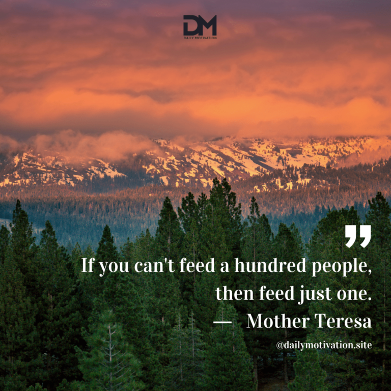 A red tinged sunrise above a snowy mountain range and forest.