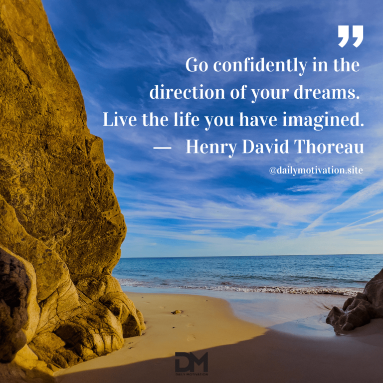 A beautiful deep blue sky beyond a tall brown sandy cliff and the beach.