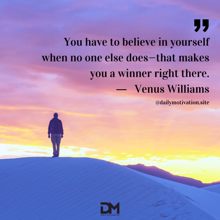 A violet and gold sky beyond a person standing on a high snowy mountain.