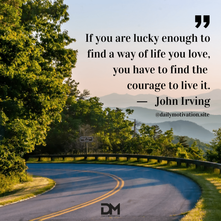 A curve in the road along a beautifully treed area with the mountains beyond.