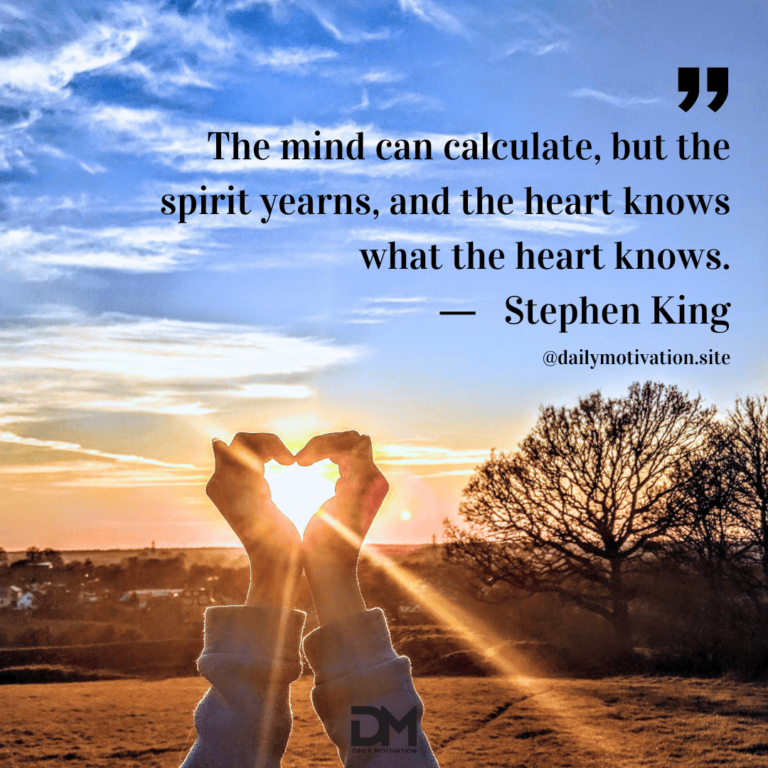 A person holds their hands up in the shape of a heart, letting the setting sun come through.