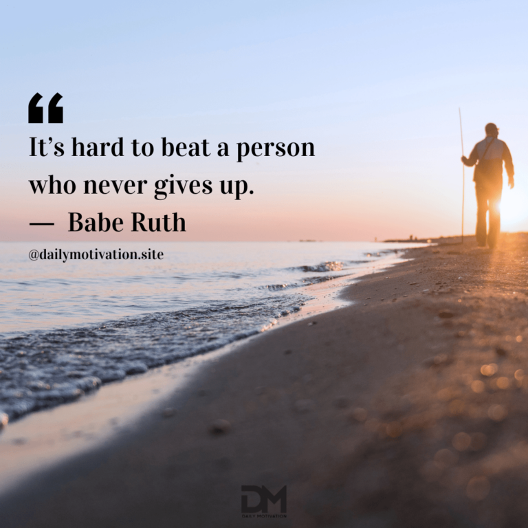 A person holding a stick walks in shadow along the shore of the beach at sunrise. Text reads: It's hard to beat a person who never gives up. - Babe Ruth