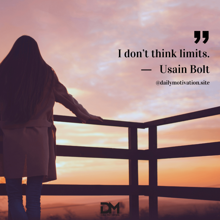 A person stands in silhouette at a railing against a pink and orange sky.
