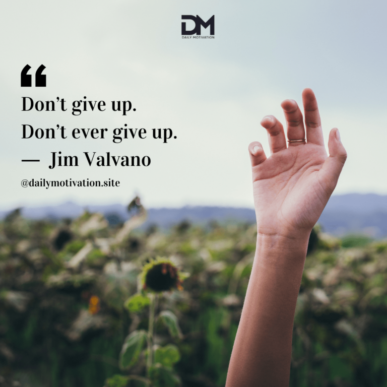 A hand reaches up to the sky above a field of flowers.