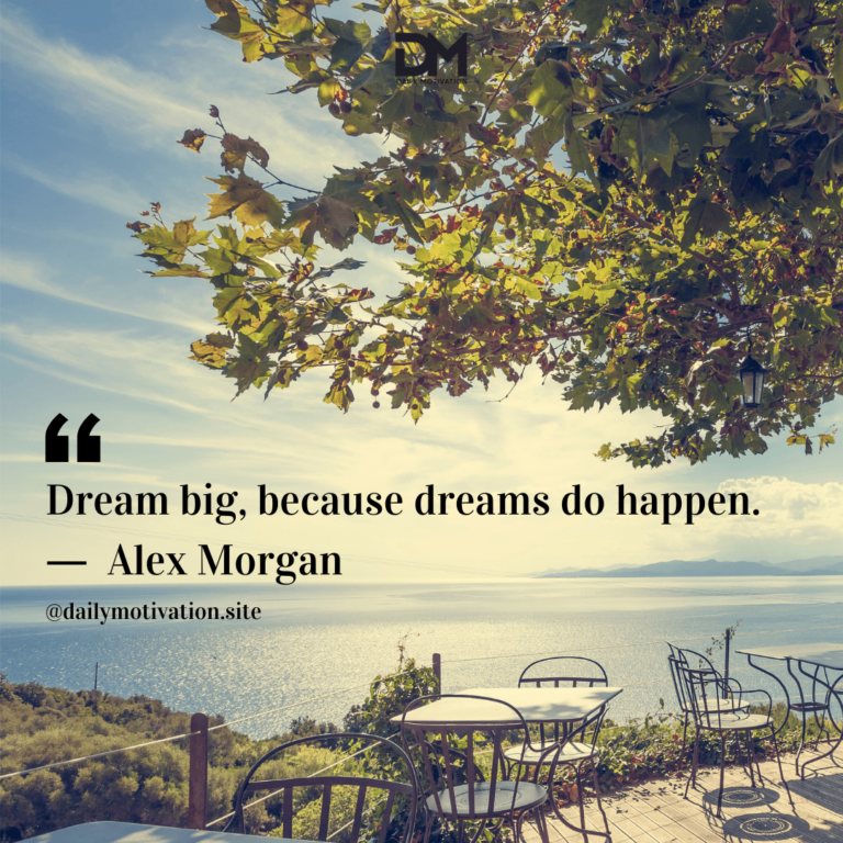 Cafe tables with a huge tree and the ocean in the distance.