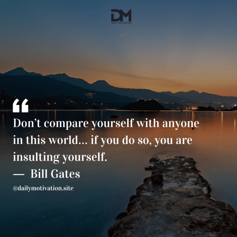 A rocky path leading to the smooth water with the mountains in the background.