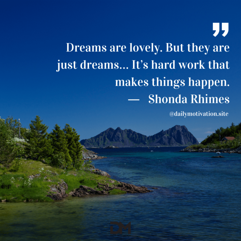 A view of a deep blue lake surrounded by green hills and mountains.