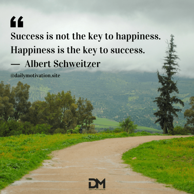 A sandy colored path lined by grass leading towards sprawling green bushes and trees beyond.