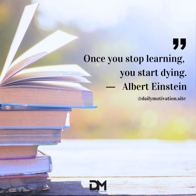 Stack of books on a table with sun shining on it.