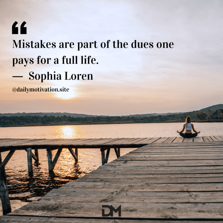 Woman doing yoga at the end of a dock under a silvery sky.