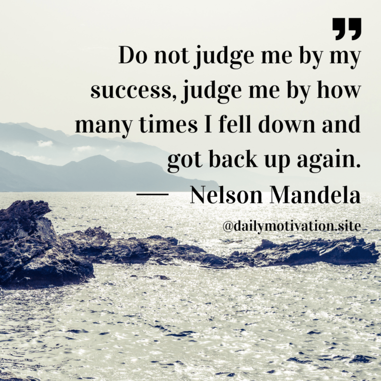 Rocks and rough water with mountains in distance.