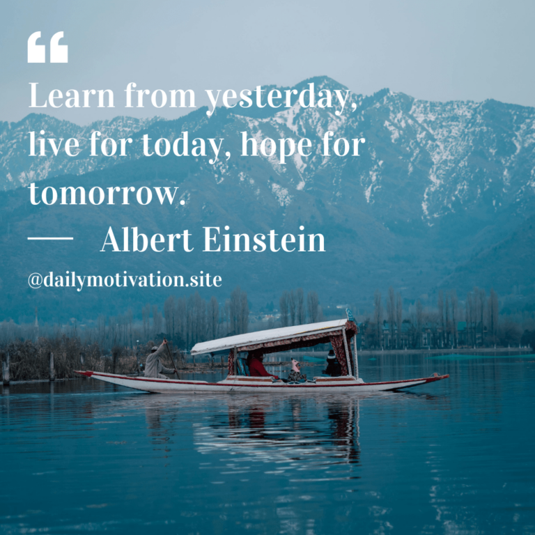 A boat floats in a quiet lake in the mountains.