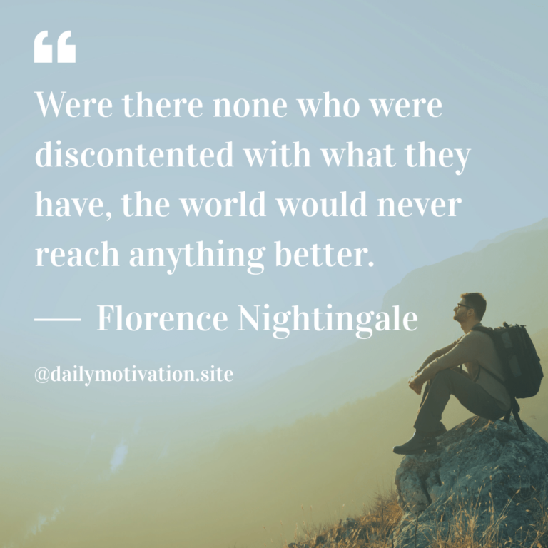 Man sits on rock with a misty blue sky in background.