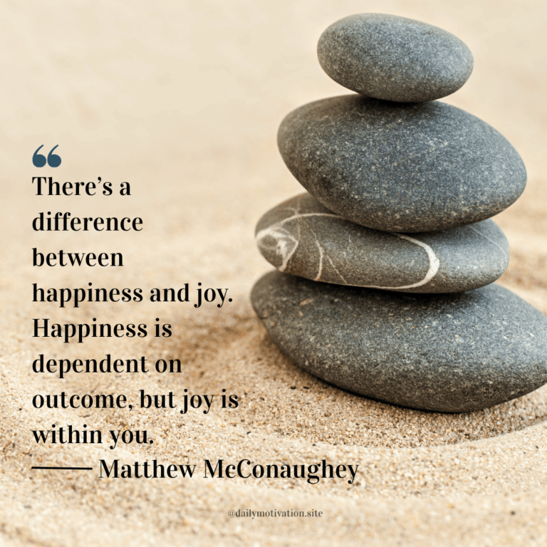 A stack of smooth stones sit on the sand.