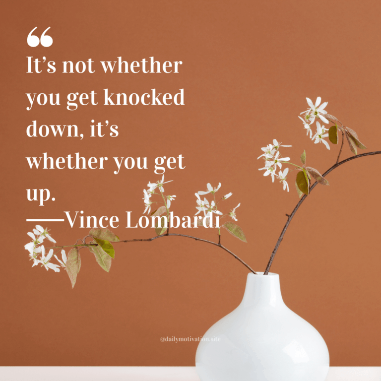 White vase of flowers against a tan background.