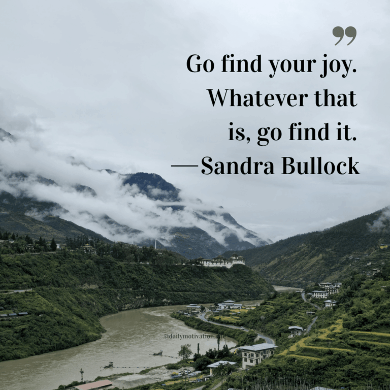 A river flows through a mountain range and town.