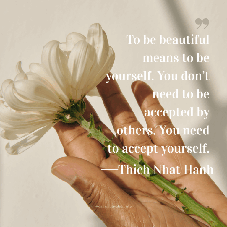 A hand holds a white flower.