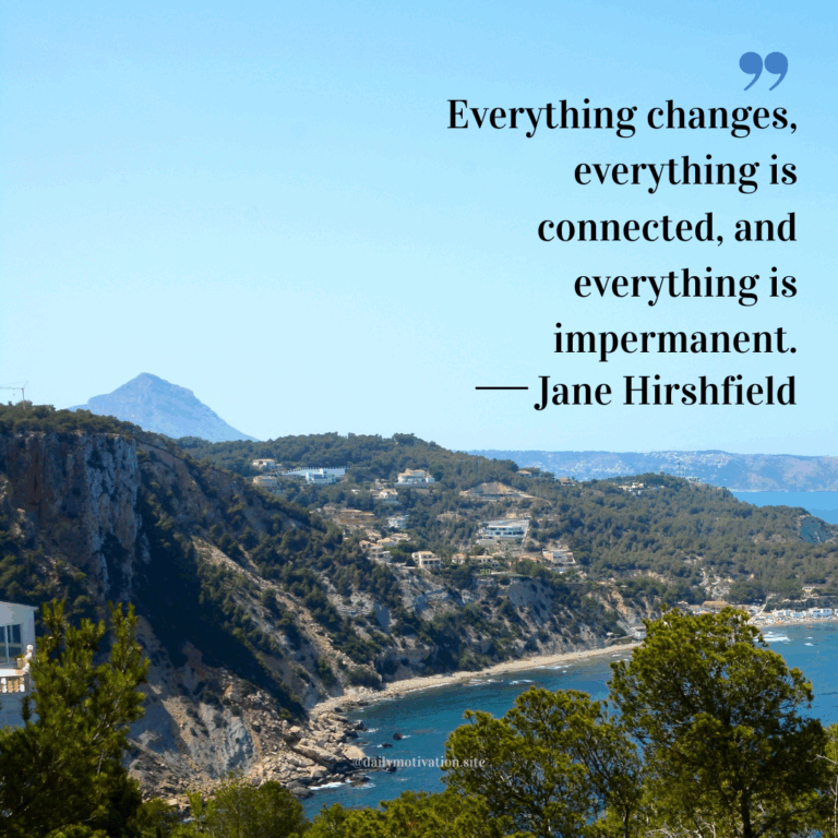 Coastal cliffs with green trees and houses overlooking the blue sea under a clear sky.