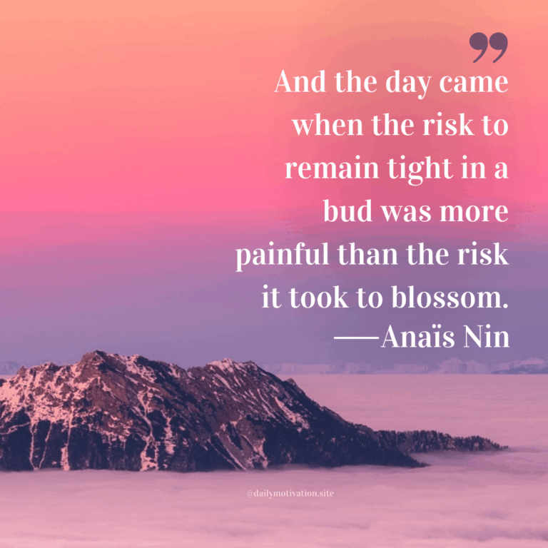 Top of a mountain peeks above the clouds with a pink and purple sky.