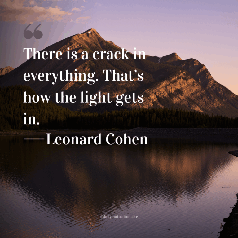 Majestic mountain peak reflecting on a calm lake during a purple and pink sunset.