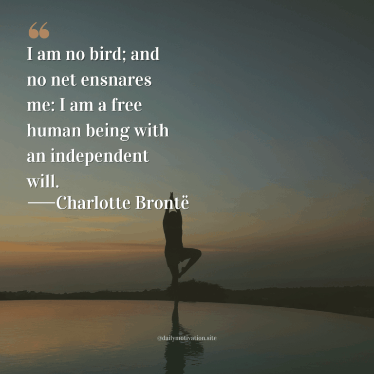 A silhouetted woman does yoga on a beach at sunset.