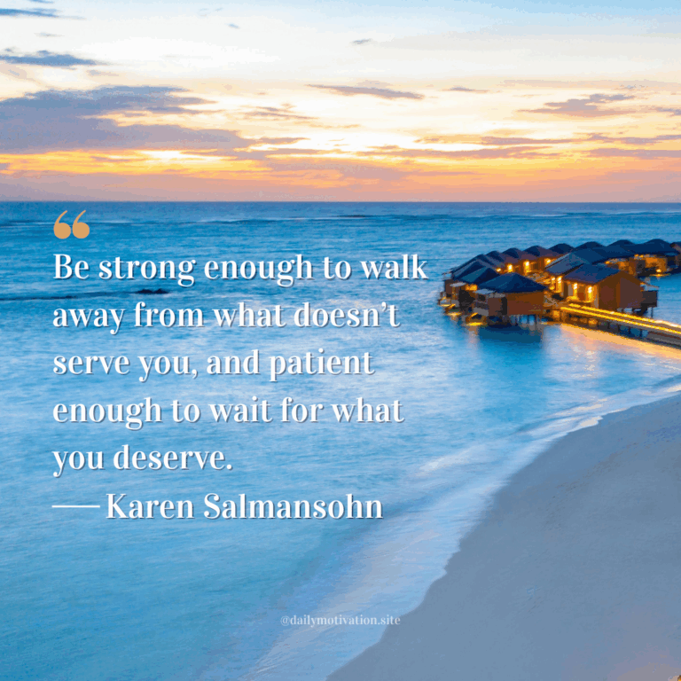 Sunset over the ocean with overwater bungalows lit up along the shore.