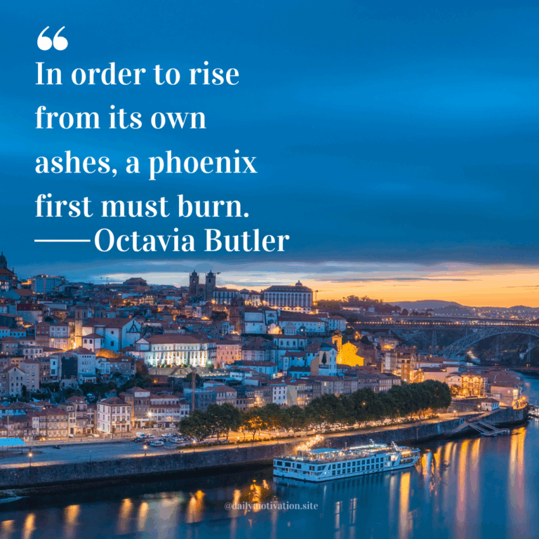 Twilight cityscape of colorful buildings along a riverside with boats docked in calm water.